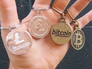 hand holding cryptocurrency keychains